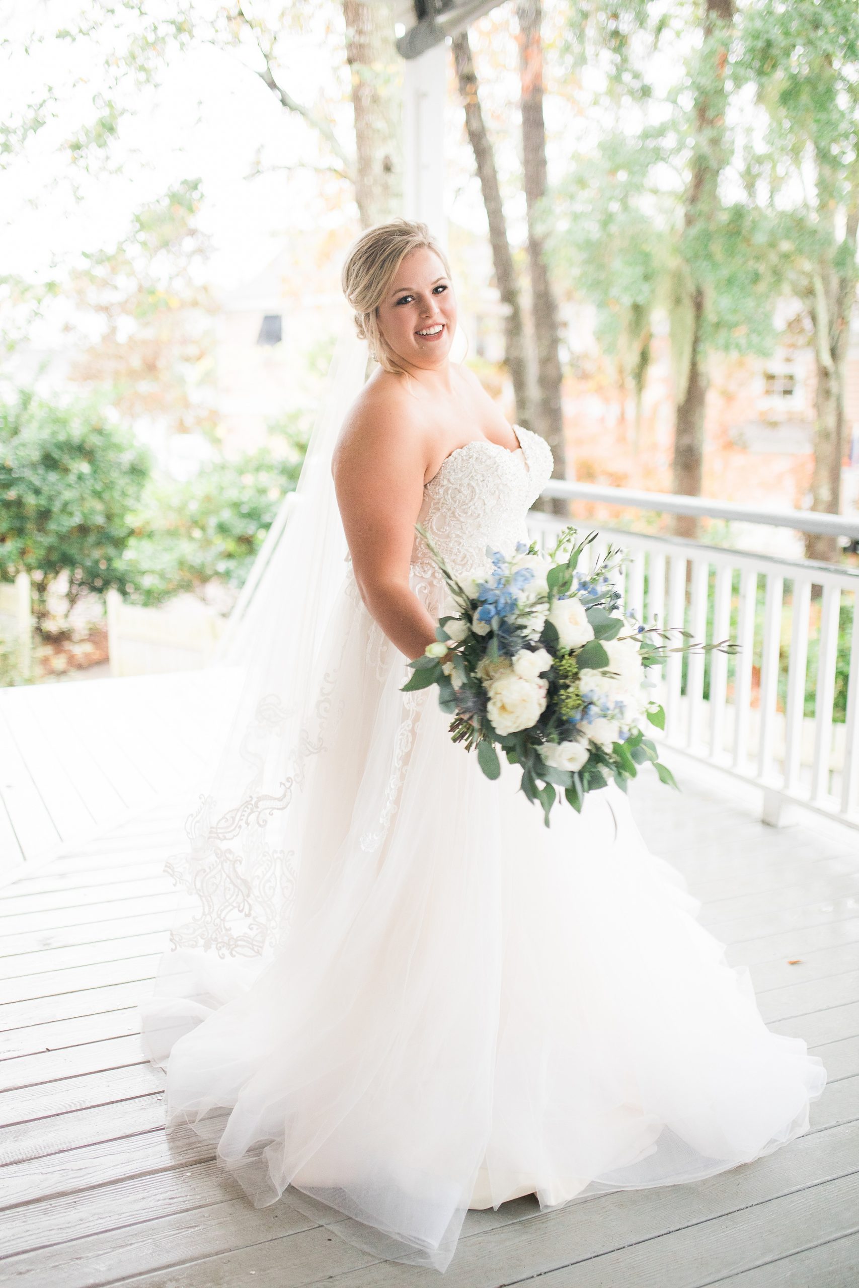 Bride holding flowers on porch