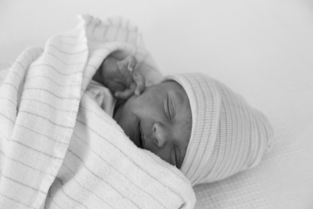 Black and White photo of newborn sleeping