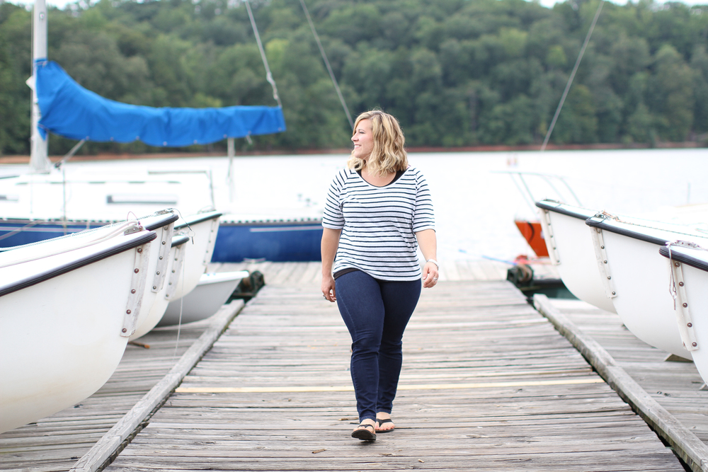Amanda walking along the dock among the boats