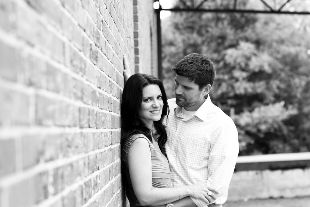 Jessica and Bryan Anniversary Portrait Black and White against Brick Wall.