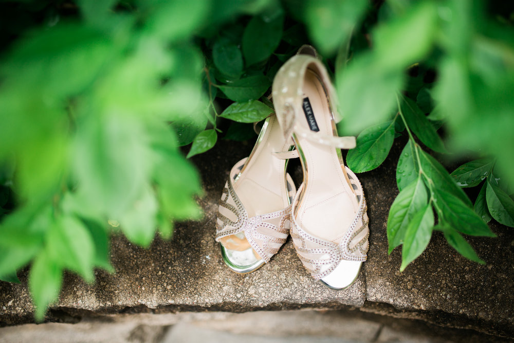 Bridal shoes among green leaves