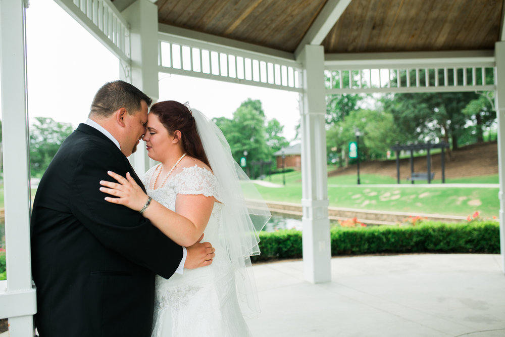 Bride and Groom holding each other in Gazebo
