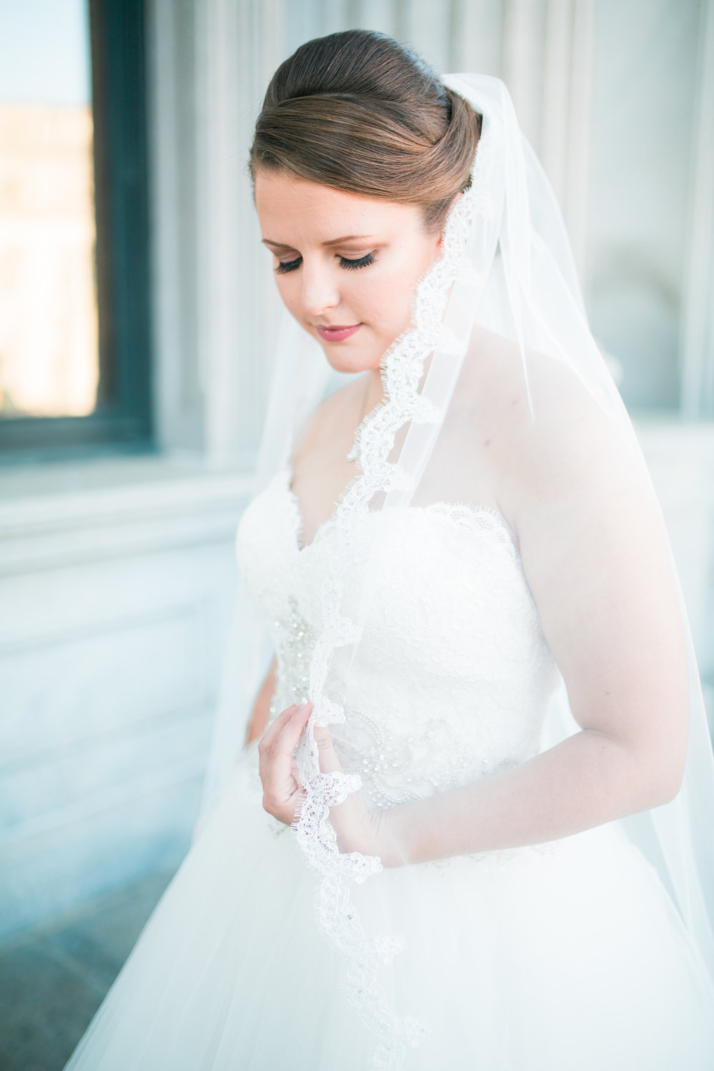 Bride looking at dress during Photo Shoot.