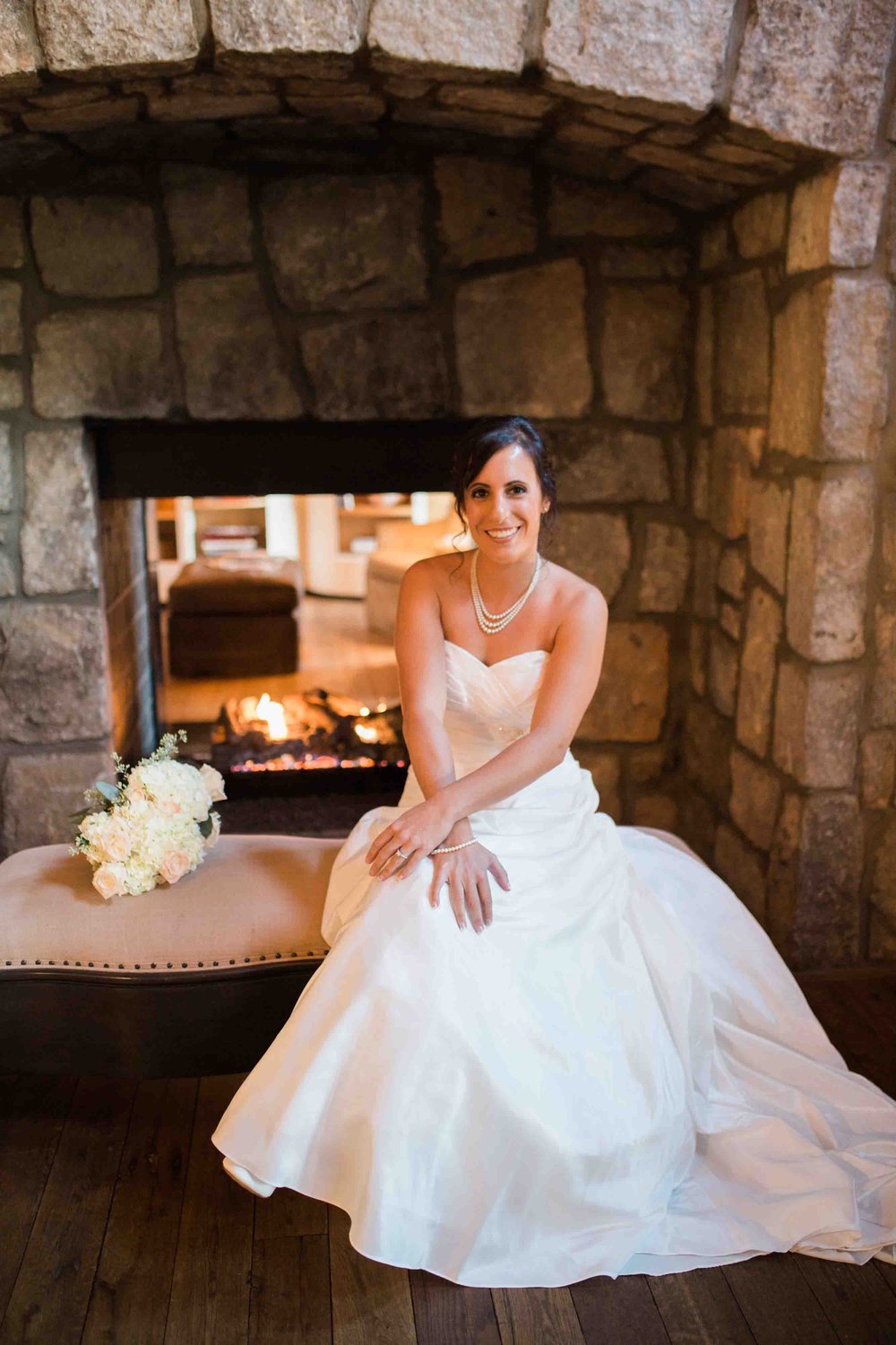 Bride in front of fireplace