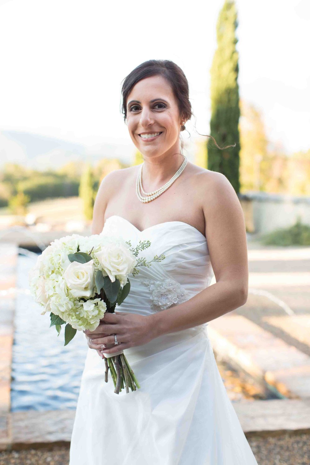Bride smiling and holding her Bouquet