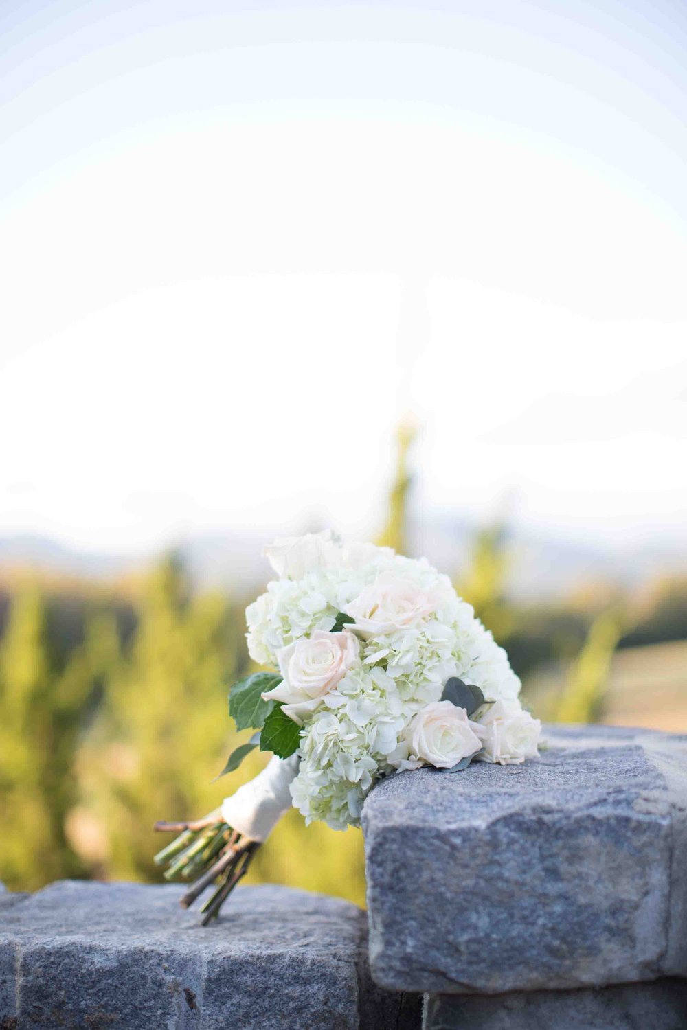 Flower Bouquet siting on stone wall