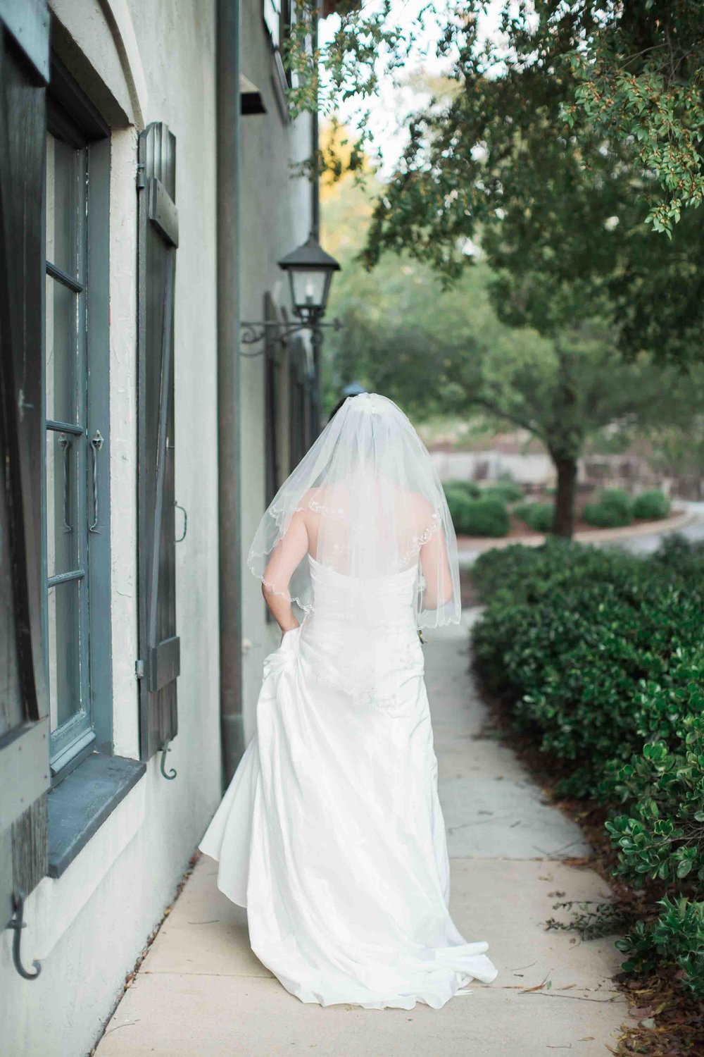 Bride walking away down sidewalk