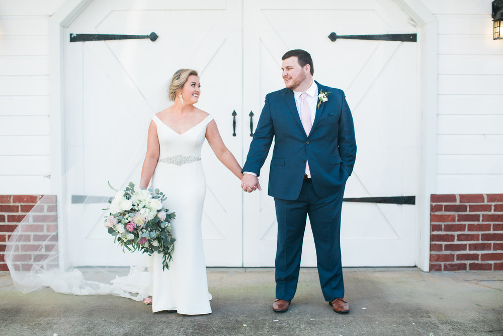 Shaun and Maddie standing in front of the entrance to Ryan Nicholas Inn