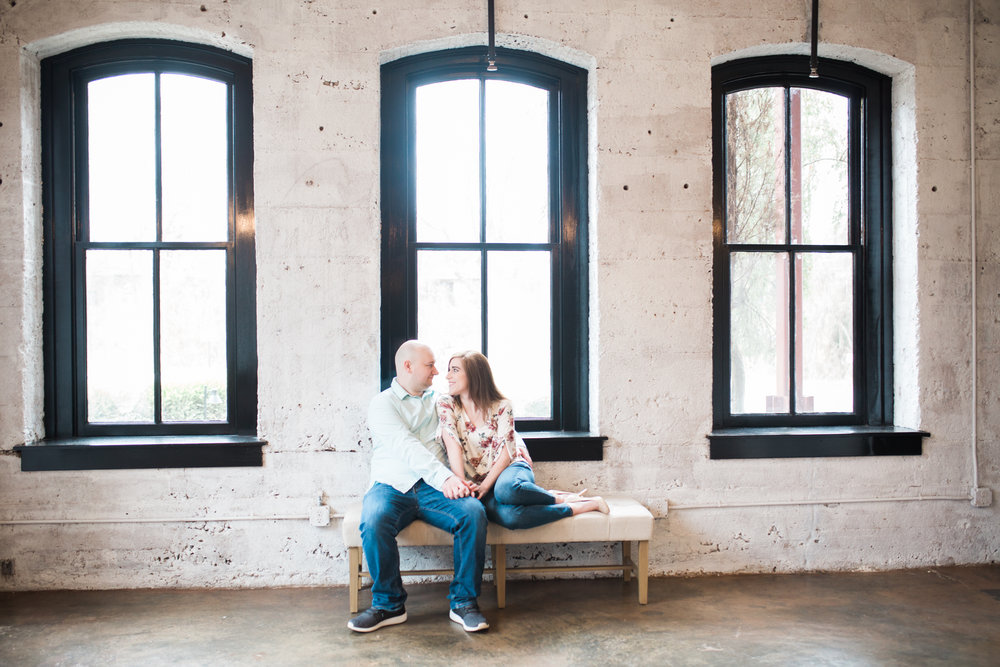 Wide Shot of couple on bench in front of windows