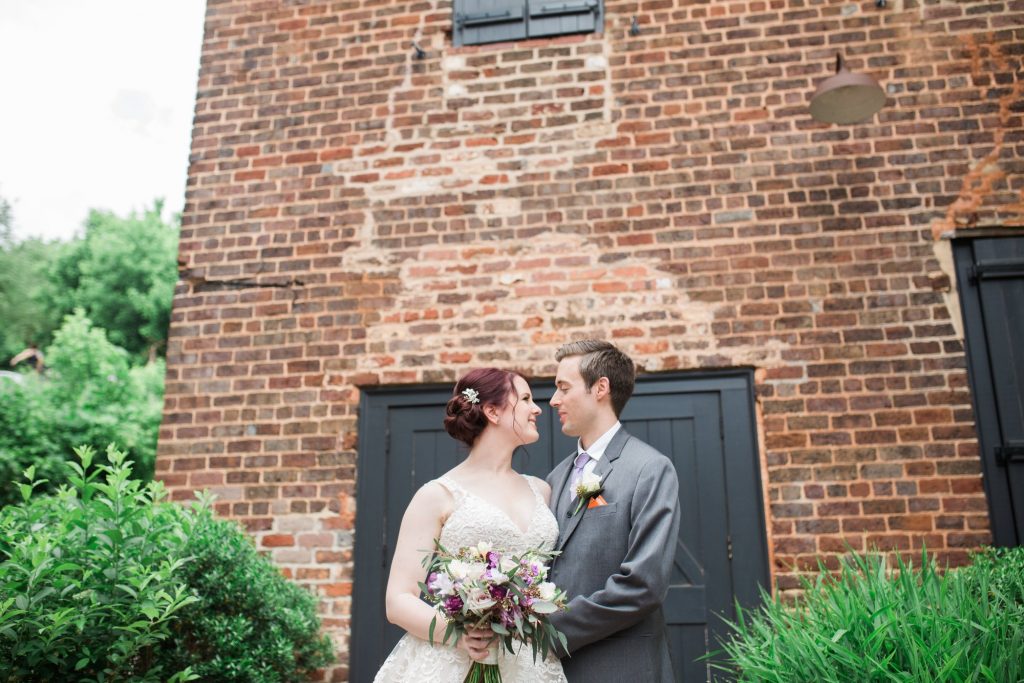 Bride and Groom in front of older Brick wall

