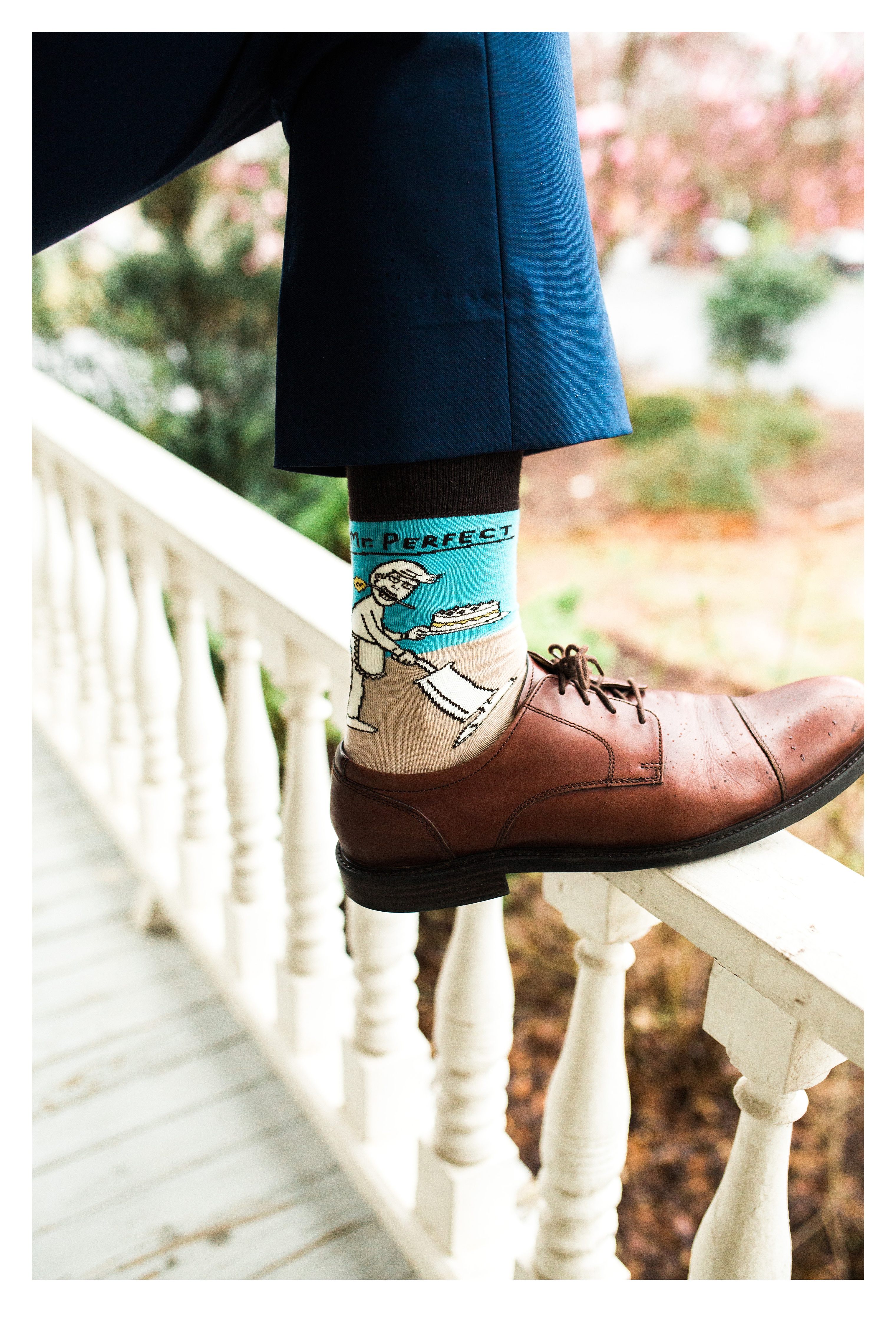 Groom showing his shoes and crazy socks