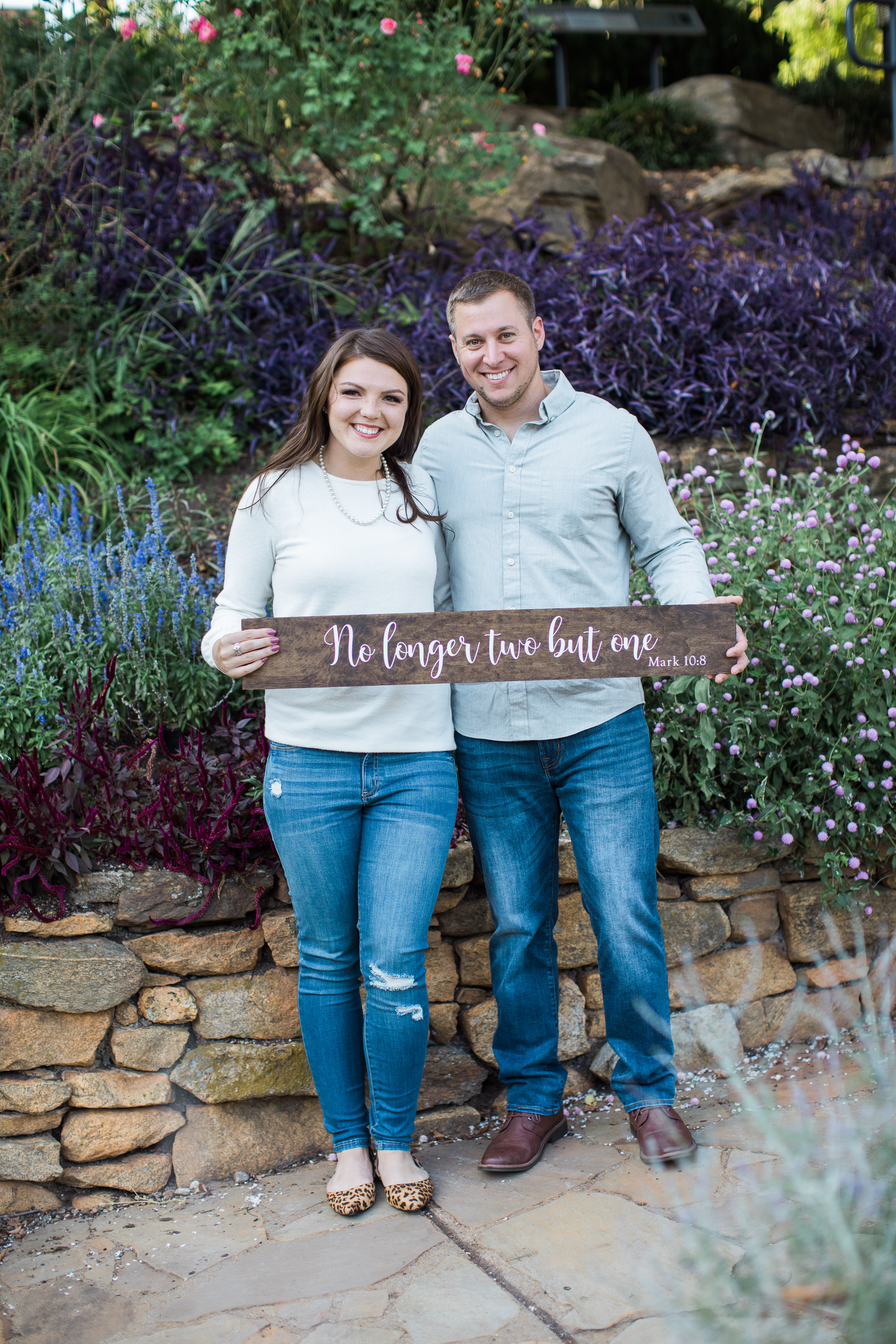 Couple holding Engagement Sign