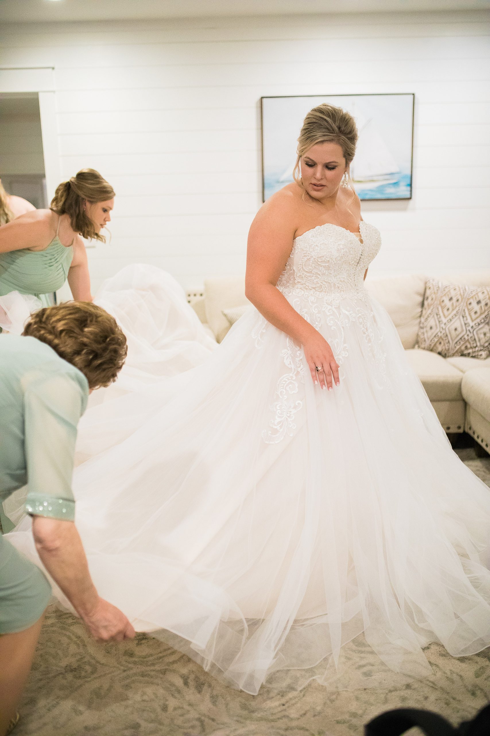 Bride getting wedding dress adjusted 1