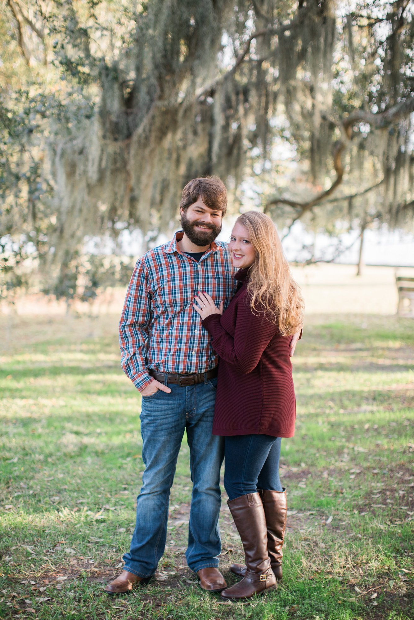Engagement couple standing under New Orleans tree