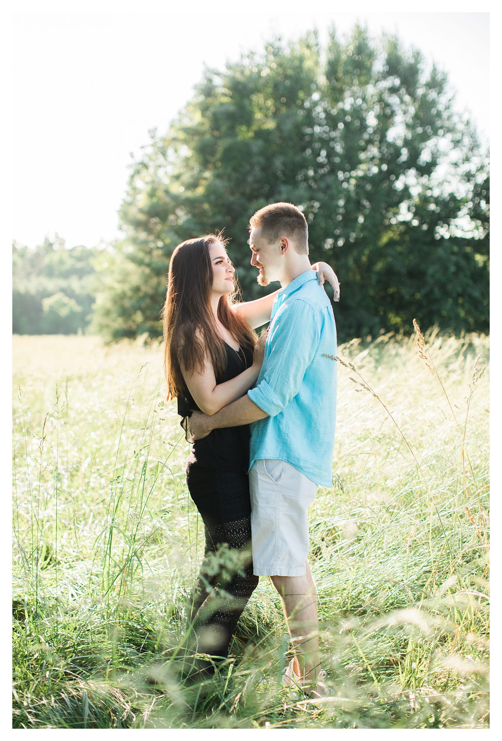 Ryan and Kayleena in a field hugging