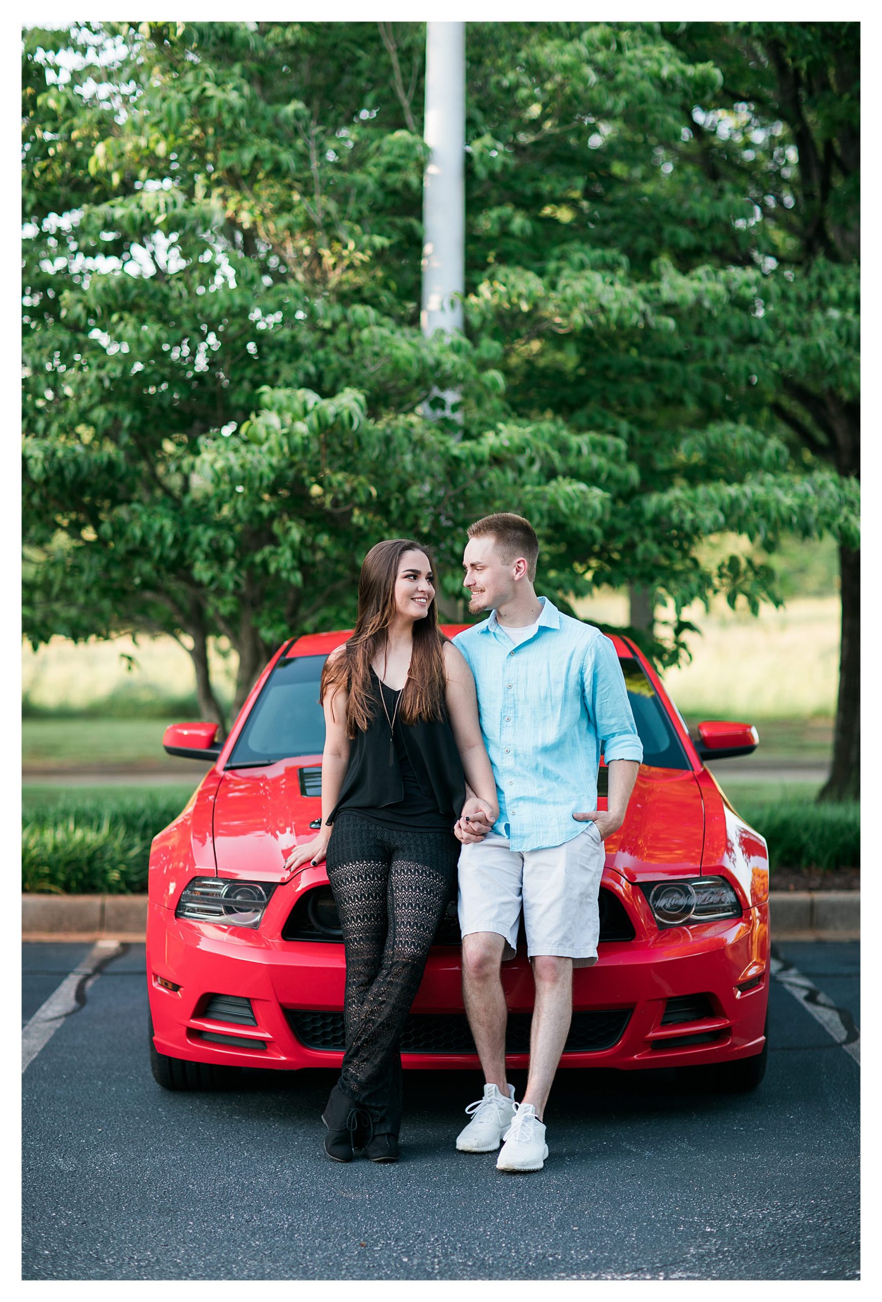 Couple in front of their Red Mustang GT