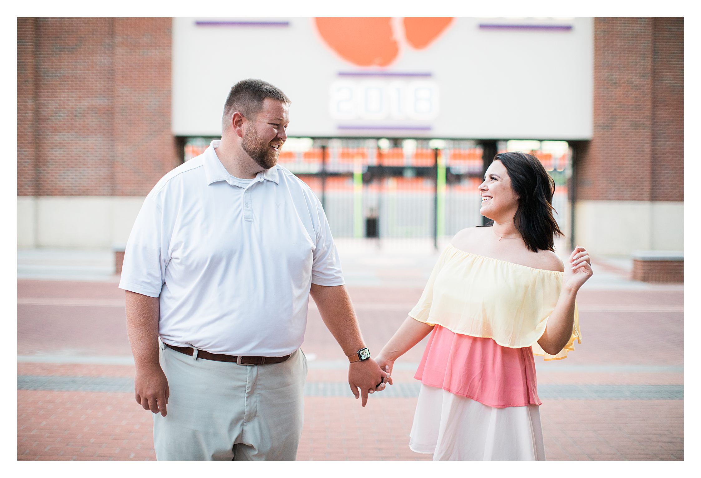 Couple in front of Clemson Stadium during engagement