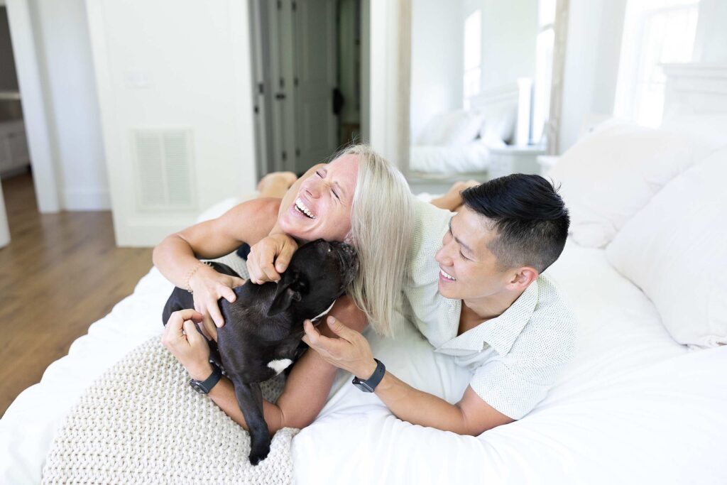 Couple laughing with their pet